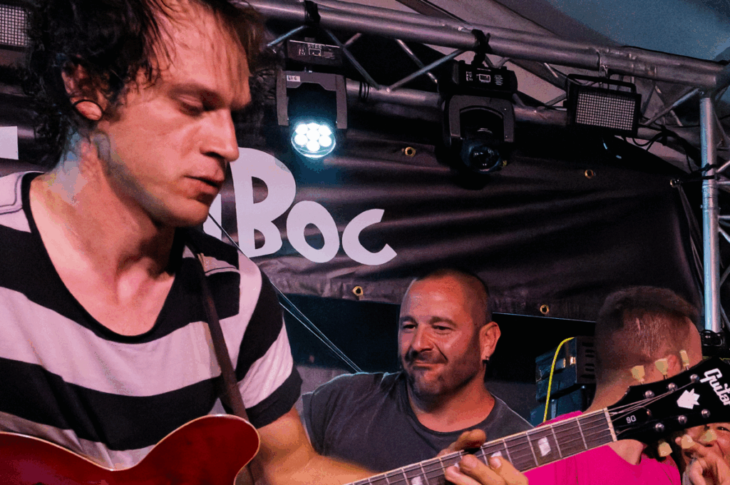 Musicien jouant de la guitare en concert festif.